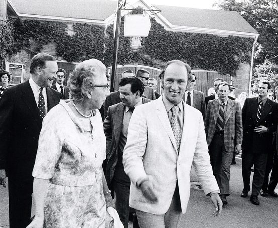 Pierre Trudeau and other officials gather outside in the stable yard of Dundurn Castle.