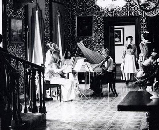 A musical ensemble performs in the entrance hall of Dundurn Castle.