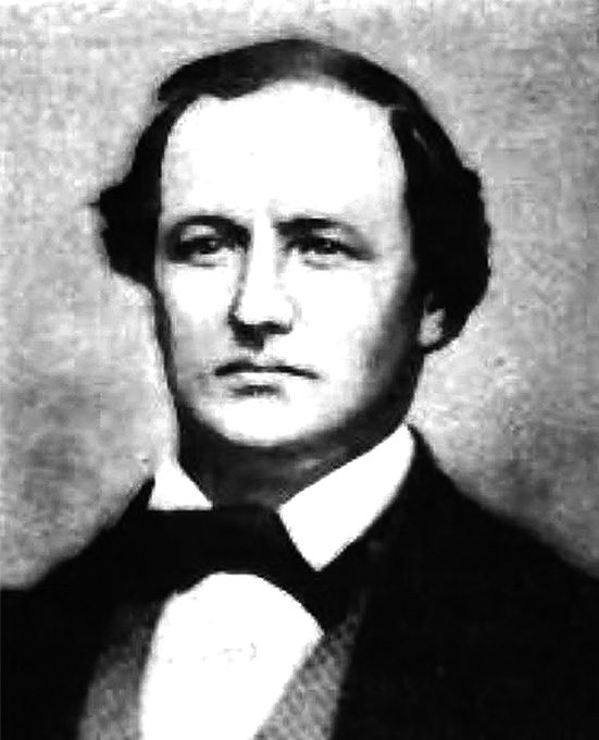 Headshot of a clean-shaven man with dark hair.