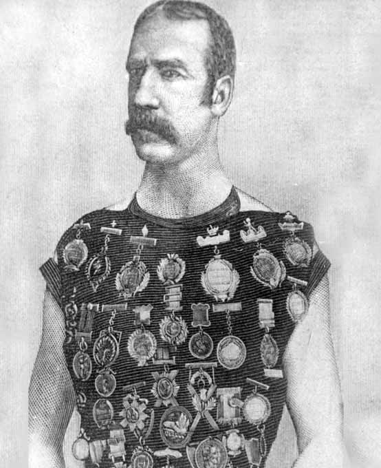 Man exhibiting many medals on his chest.