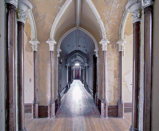Gothic revival interior view down long corridor.