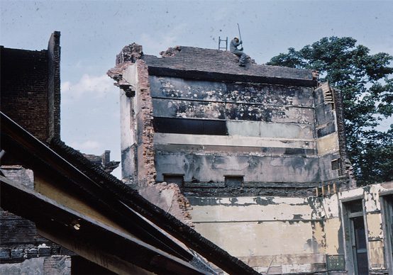 A worker can be seen atop of a wall on site after a devastating fire reduces Bennetto School to rubble.