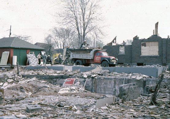A work crew with a dump truck on site after a devastating fire reduces Bennetto School to rubble.