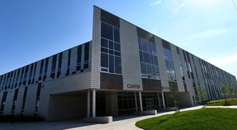 New multi level building with many windows and white brick facade.