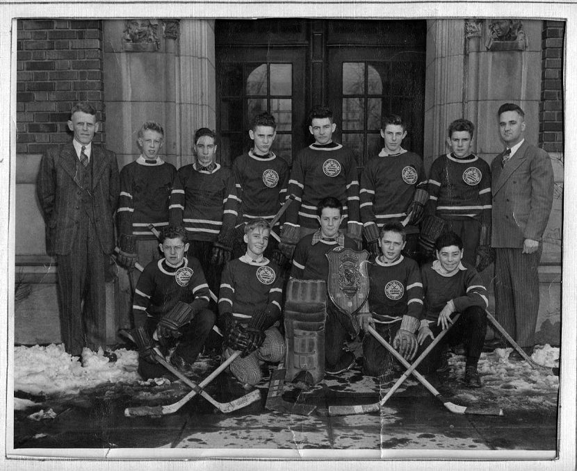 Eleven members of the boys hockey team and two coaches circa 1940.