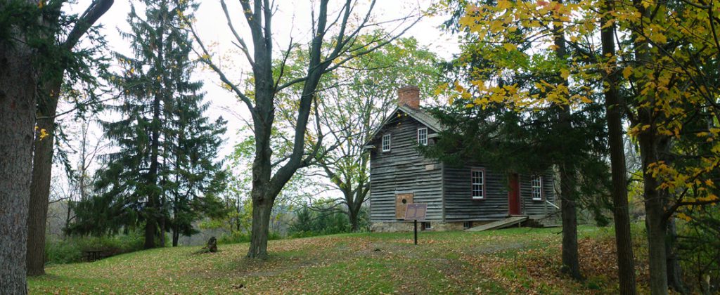 Early nineteenth century two story four room house with wood cladding.