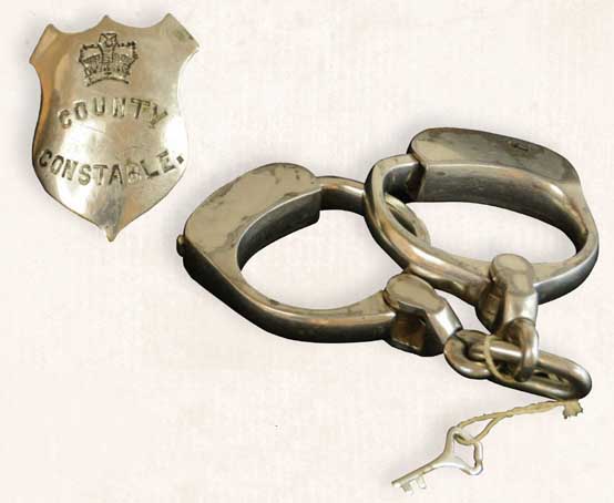Handcuffs and constable badge.