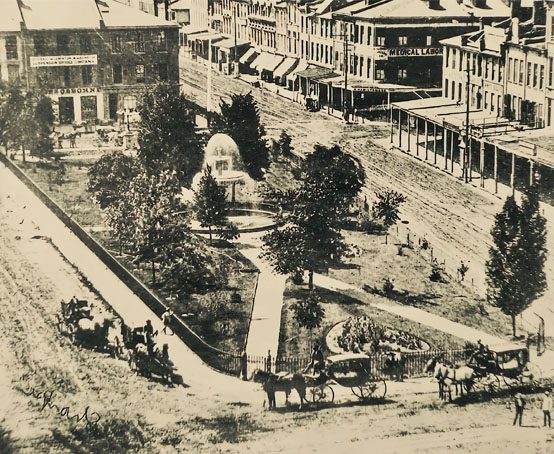 Aerial view of Gore Park with fountain and nearby horses and buggies.