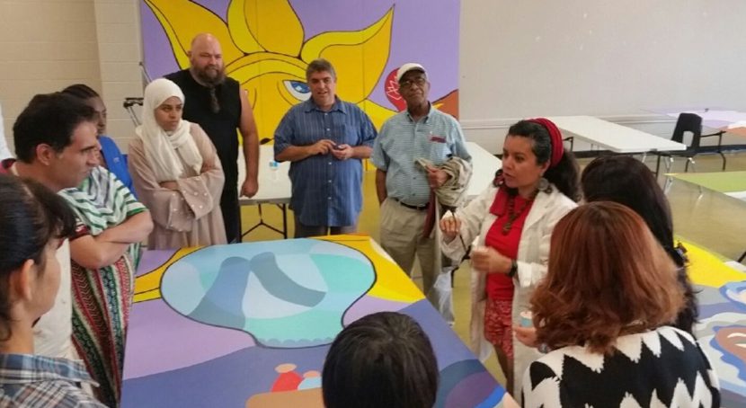 Journey of Hope mural volunteers in discussion.