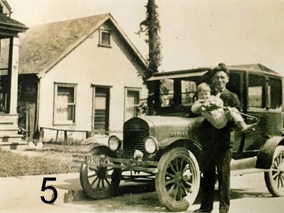 A man, child, and car in front of 100 Manchester Street 1930.