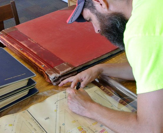 Man tracing fire insurance maps as a foundation to completing the Brightside memory map.