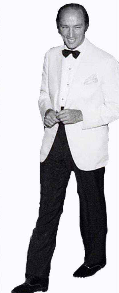 Detail of Pierre Trudeau in a white formal dinner jacket black pants and bow tie.
