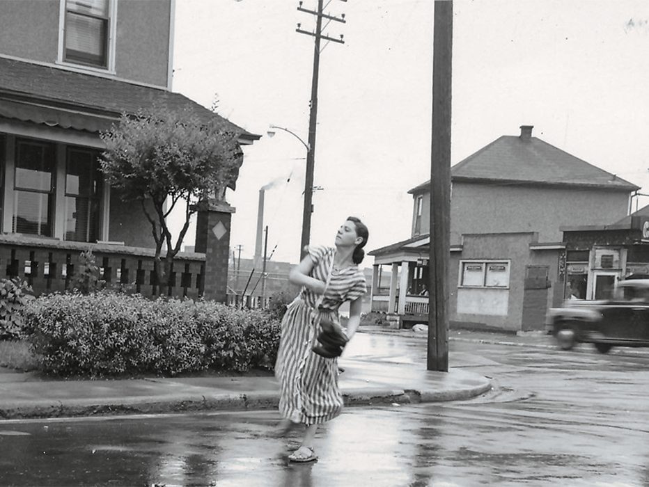 Woman throwing a baseball down Birmingham Street at Burlington Street, near the Brightside Hotel.