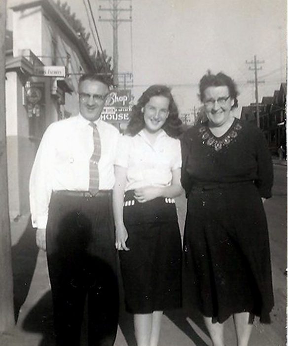 Three people standing on Burlington Street near the Brightside House.