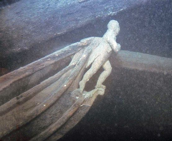 Carving of a male figure on the bow of a ship.
