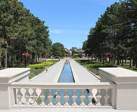Gage Park Fountain Watercourse looking northward and flanked by straight walking paths and gardens.