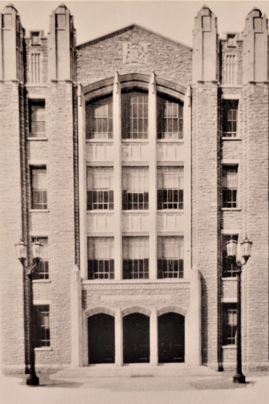 Westdale S. S. main arched doors with lamp posts and symmetrical upward thrust of the brick and window facade.