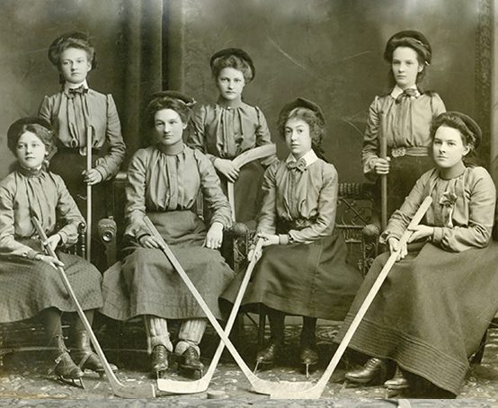 Hamilton Thistle Club Women's Hockey Team, seven members wearing skirts and skates sitting for a photo 1904.