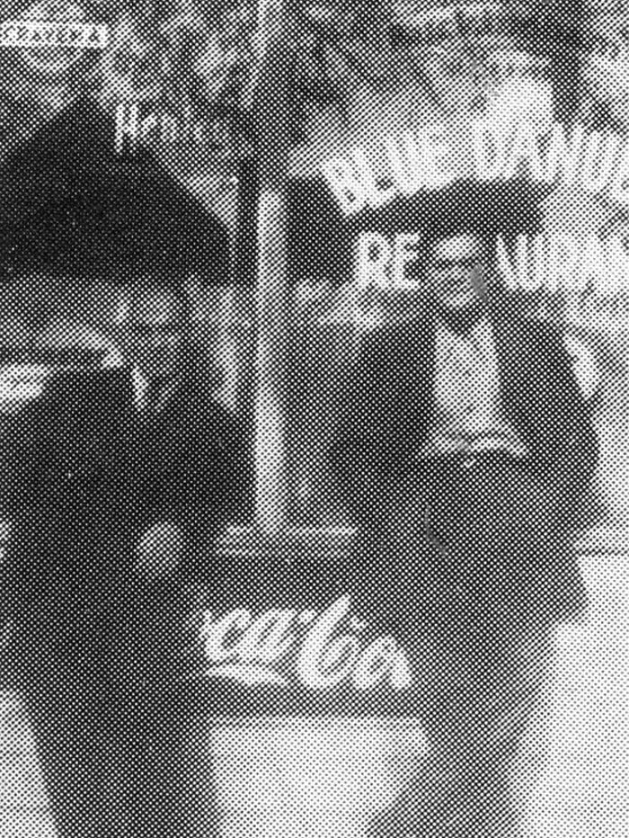 Two men in suits standing outside of the Blue Danube Restaurant.