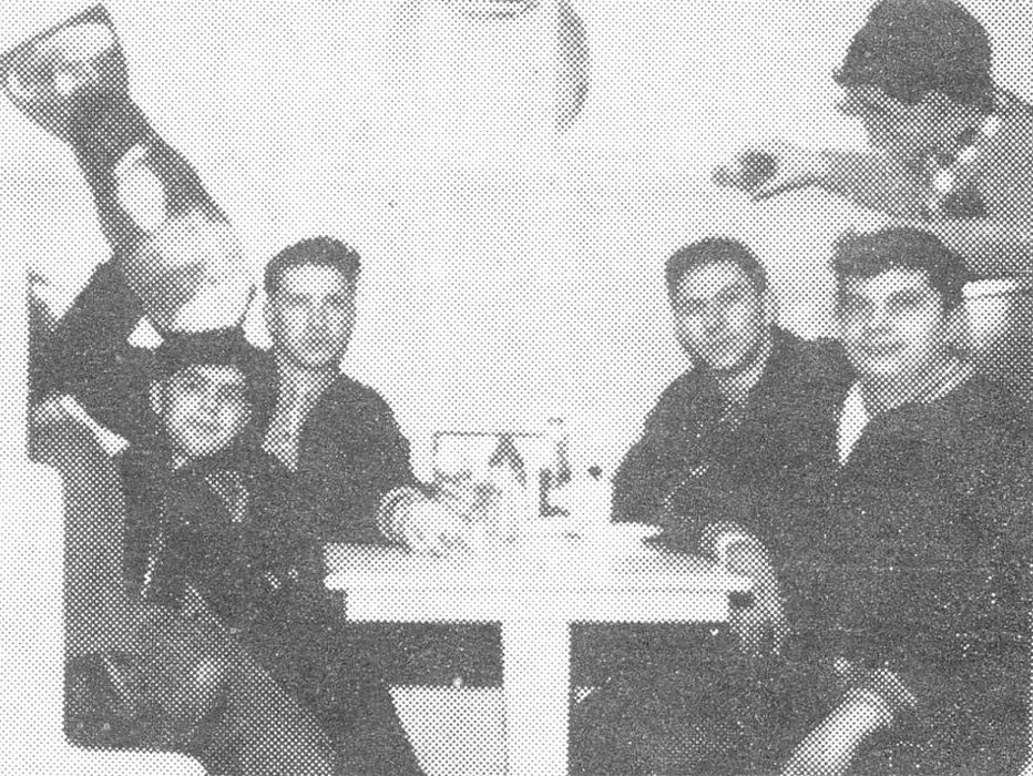Five young men sitting in a booth inside the Blue Danube Restaurant.