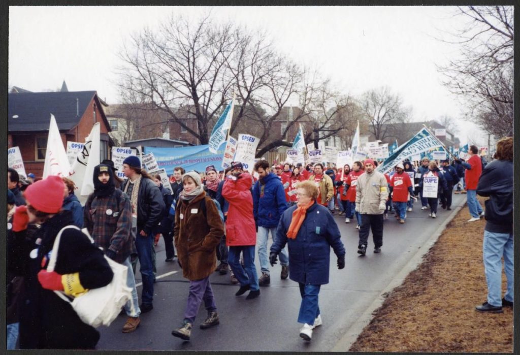 Union members marching with signs and banners.
