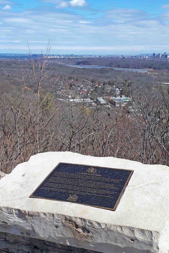 Commemorative plaque imbedded into stone wall overlooking the Hamilton vista.