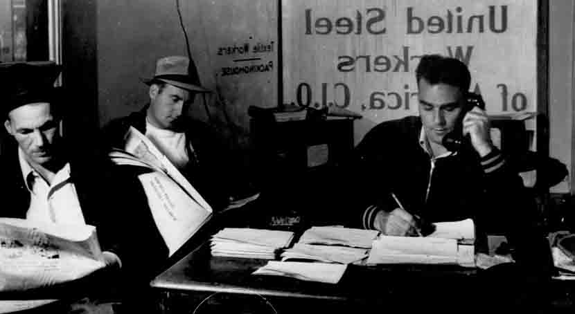 In the United Steel Workers office, three men read and work the phone.