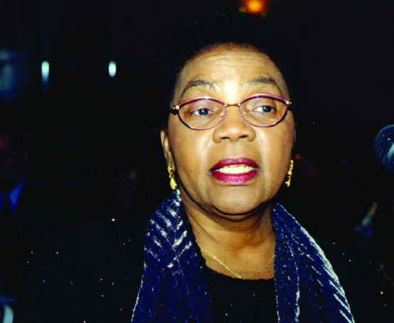 Candid photo of a mature woman wearing pink rimmed glasses.