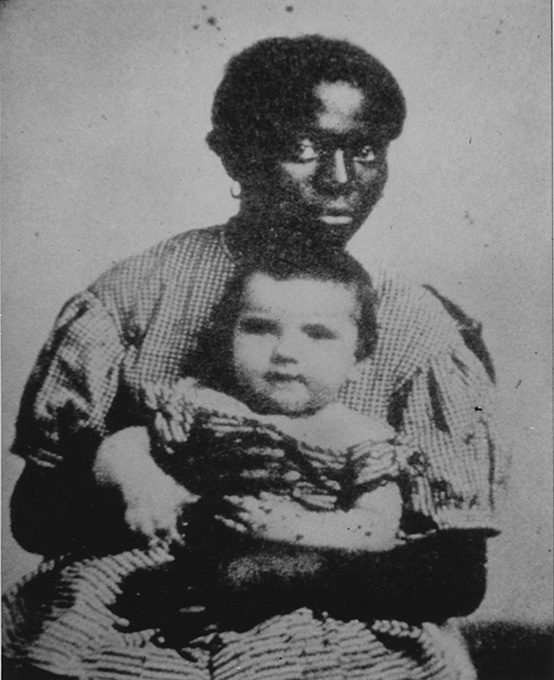 A young woman with an infant on her lap.