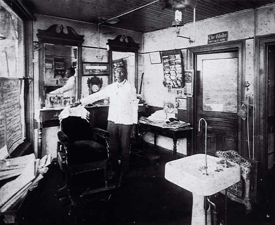 A barber inside his barbershop.