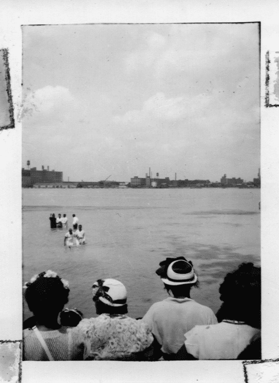 People gathered for a Baptism ceremony in the Detroit river.