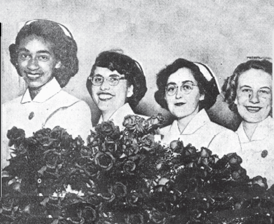 Four young women graduate from nursing school.