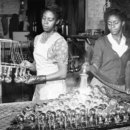 Two women working on an industrial assembly line.