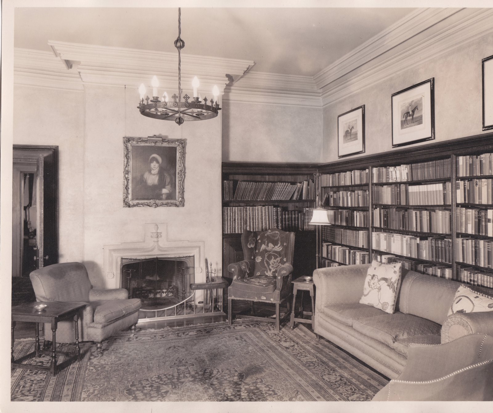 The library at Auchmar with built-in bookshelves and a fireplace